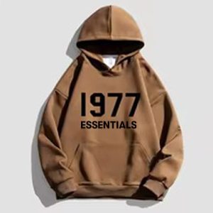 The 1977 Essentials Designer Hoodie in dark brown offers a sleek, comfortable fit with soft fleece lining and adjustable hood.