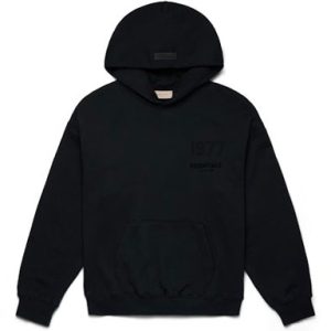 The 1977 Essentials Black Pullover Chest Logo Hoodie features a classic design with a bold "1977" logo on the chest. Crafted from soft, high-quality fabric, this hoodie offers a comfortable and relaxed fit.