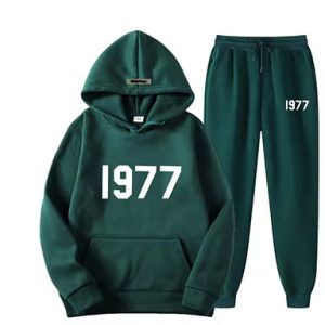 Shop the Oversized 1977 Essentials Tracksuit in Green for a perfect blend of comfort and style. Crafted with a soft cotton-polyester blend
