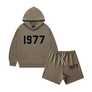 The 1977 Style Essentials Hoodie and Shorts Combo for kids offers a trendy and comfortable outfit. The hoodie features a bold "1977" graphic, while the matching shorts provide a relaxed fit, making it perfect for casual wear.