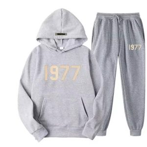 Shop the Oversized 1977 Essentials Tracksuit in Gray for a perfect blend of comfort and style. Crafted with a soft cotton-polyester blend