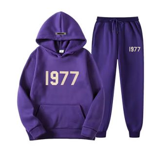 Shop the Oversized 1977 Essentials Tracksuit in Purple for a perfect blend of comfort and style. Crafted with a soft cotton-polyester blend