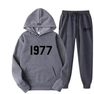 Shop the Oversized 1977 Essentials Tracksuit in Gray With Black Logo. Enjoy comfort and style with this trendy, relaxed-fit tracksuit.