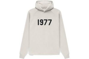 Shop the Fear of God Essentials 1977 Knit Hoodie in Wheat. Cozy knit fabric, adjustable hood, and a perfect blend of style and comfort.
