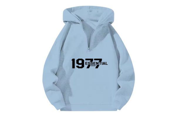 The 1977 Essential Half-Zip Hoodie in Cozy Sky Blue combines classic style with modern comfort, offering a relaxed fit for all-day casual wear.