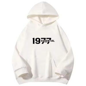 The 1977 Essentials Hoodie in White combines style and comfort with a sleek design, perfect for everyday wear. Stay cozy and fashionable all day long.