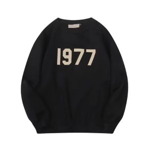Shop the 1977 Essentials Sweatshirt in Black for premium comfort, durability, and style. Perfect for casual outings, lounging, and everyday wear