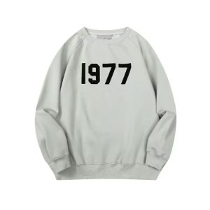 Shop the 1977 Essentials Sweatshirt in Light Gray. Soft cotton fleece, classic fit, ribbed cuffs, and durable design for ultimate comfort and style.