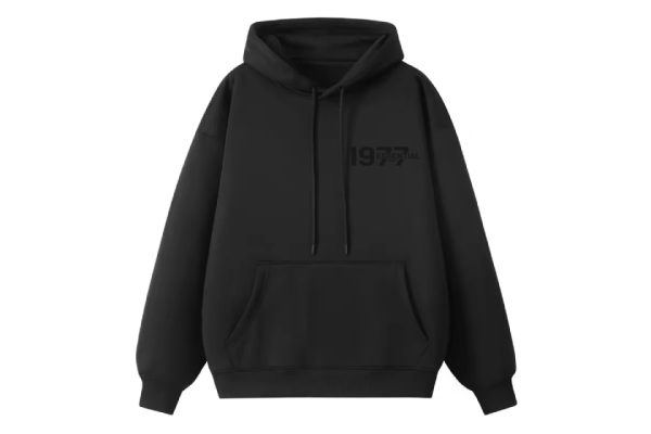 1977 Essentials Hoodie in Timeless Black, a classic wardrobe staple designed for ultimate comfort and style. Perfect for any occasion.
