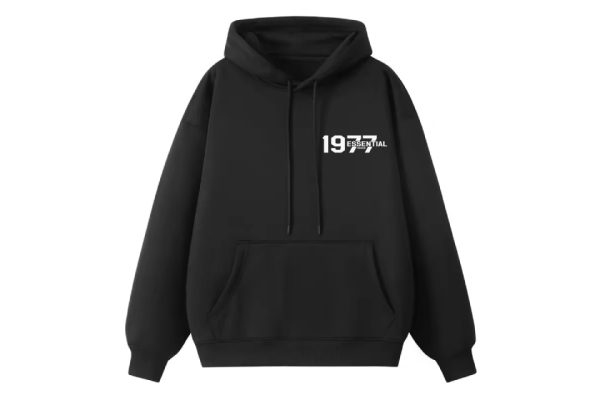 The 1977 Essentials Hoodie in black. Designed for ultimate comfort and sleek simplicity, it’s the perfect addition to any wardrobe.