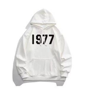 1977 Essentials Hoodie blends timeless design and everyday comfort, featuring a soft fleece lining and adjustable, versatile style.