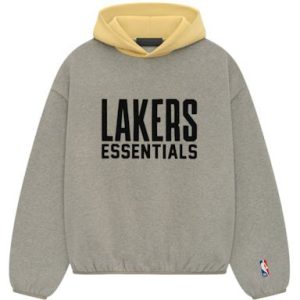 The Essentials NBA Lakers Hoodie in Warm Heather. Featuring bold Lakers branding, this hoodie offers comfort and a trendy look for any fan.
