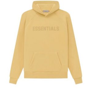 The Essentials Hoodie in Light Tuscan, featuring a relaxed fit, premium cotton-blend fabric, and minimalist design for ultimate comfort and versatility.