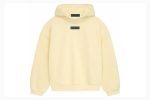 The Essentials Pullover Hoodie in Garden Yellow offers comfort, style, and warmth with a cozy fit, perfect for casual wear and lounging.