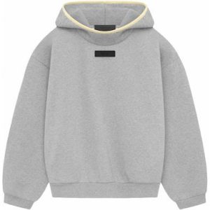 The Essentials Hoodie in Light Heather Grey and Garden Yellow combines comfort and style, featuring a relaxed fit, adjustable hood, and vibrant accents.